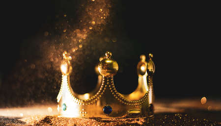 the golden crown of the king onGold abstract bokeh backgroundの写真素材