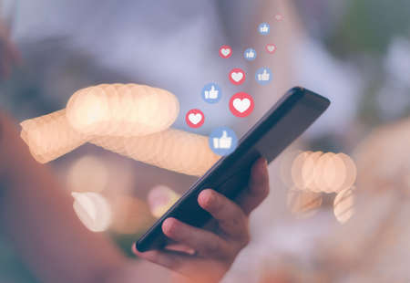 Hand using smartphone with Social media concept