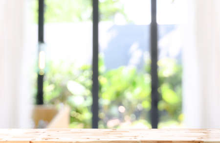 Wooden board empty table in front of blurred background. wood over blur in living room interior, can...