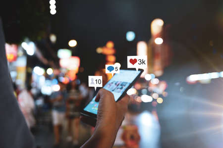 Hand using smart phone with Social media conceptの写真素材