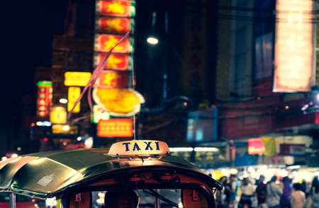 Tuk-Tuk Taxi sign with defocused lights blur in Chinatown in Bangkok at night, Thailand, Southeast asiaのeditorial素材