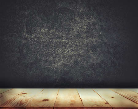 Empty top of wood table with grunge concrete wall texture backgroundの写真素材