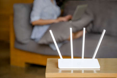 Wireless router and woman using a laptop in office. router wireless broadband home laptop computer...