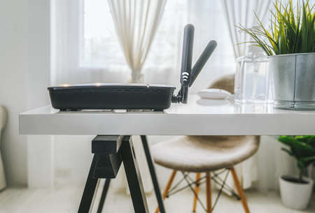 closeup of a wireless router on living room at home office, equipment  for working from home, while in quarantine isolation during the Covid-19 health crisis.の写真素材