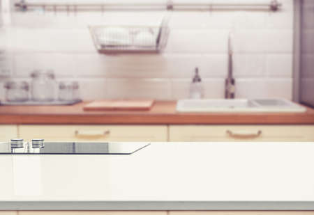 Wood table top on blur kitchen room background. can be used for display or montage your productsの写真素材