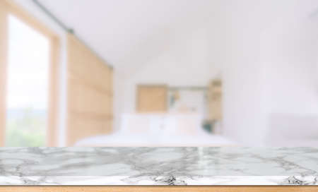 Wooden table top in front of blurred bedroom interior background.  for montage or display your productsの写真素材