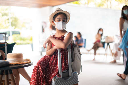 Pretty asian girl happy tourists to travel wearing mask to protect from Covid-19 on they holidaysの写真素材