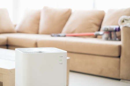 air purifier a living room,  air cleaner removing fine dust in house. protect PM 2.5 dust and air pollution conceptの写真素材