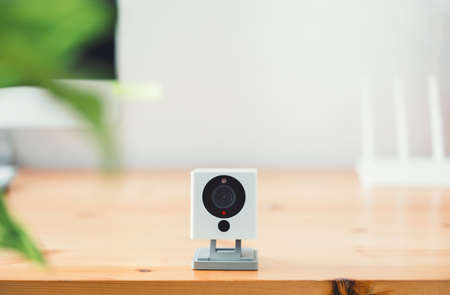 The CCTV security camera on Wood table in home, ip camera