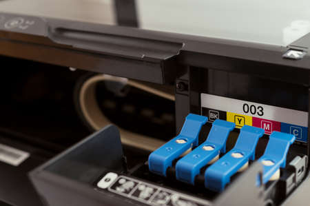 Replacement of CMYK set of ink cartridges in printerの写真素材