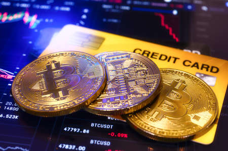 Golden coin bitcoin cryptocurrency with a credit card, payment operationsの写真素材