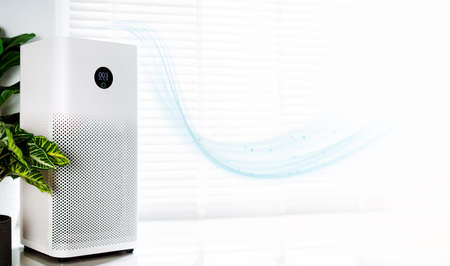 air purifier a living room, air cleaner removing fine dust in house. protect PM 2.5 dust and air pollution conceptの写真素材