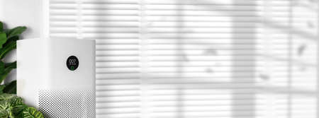 air purifier a living room, air cleaner removing fine dust in house. protect PM 2.5 dust and air pollution conceptの写真素材
