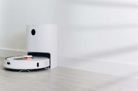 robotic vacuum cleaner on wood floor smart cleaning technologyの写真素材