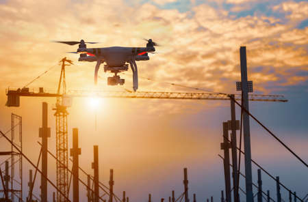 Drone over construction site. video surveillance or industrial inspection