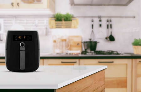 Air fryer machine cooking potato fried in kitchen. Lifestyle of new normal cooking.の写真素材