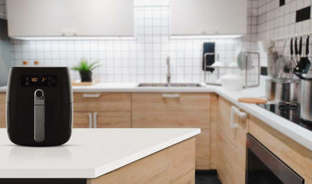 Air fryer machine cooking potato fried in kitchen. Lifestyle of new normal cooking.の写真素材