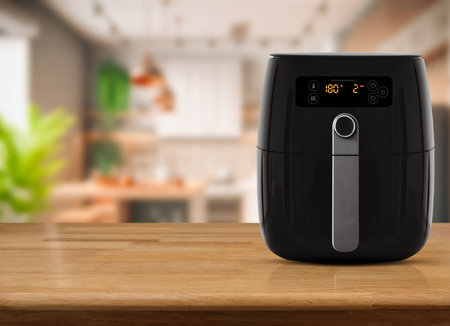 Air fryer machine cooking potato fried in kitchen. Lifestyle of new normal cooking.の写真素材