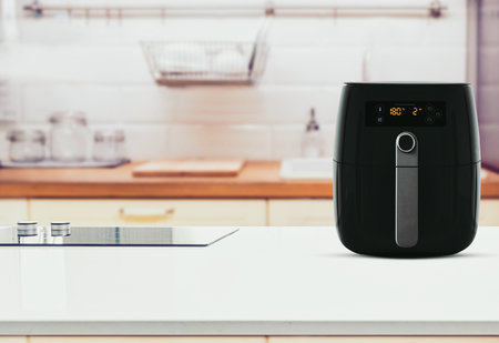 Air fryer machine cooking potato fried in kitchen. Lifestyle of new normal cooking.の写真素材