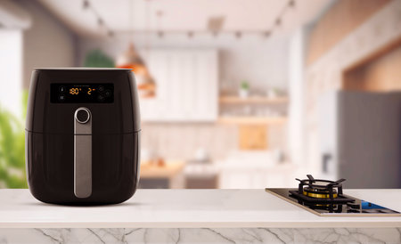Air fryer machine cooking potato fried in kitchen. Lifestyle of new normal cooking.の写真素材