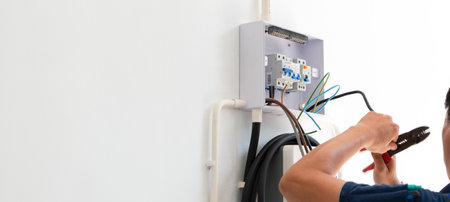 Certified male Electrician Installing Home EV Charger