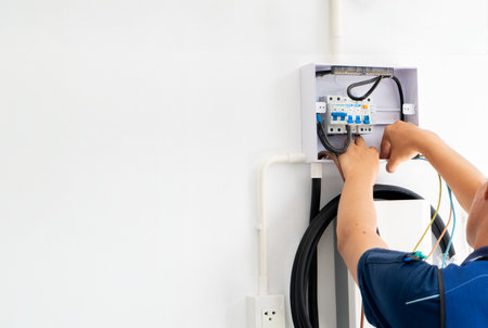 Certified male Electrician Installing Home EV Chargerの写真素材
