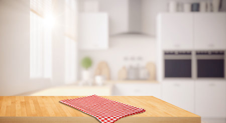 Wood table top on blurred kitchen background. can be used mock up for montage products display or design layoutの写真素材