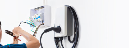 Certified male Electrician Installing Home EV Chargerの写真素材