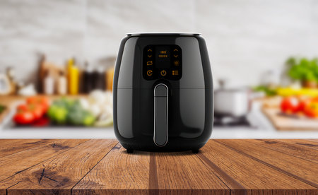 Air fryer machine cooking potato fried in kitchen. Lifestyle of new normal cookingの写真素材
