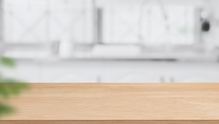 Wood table top on blurred kitchen background. can be used mock up for montage products display or design layoutの写真素材