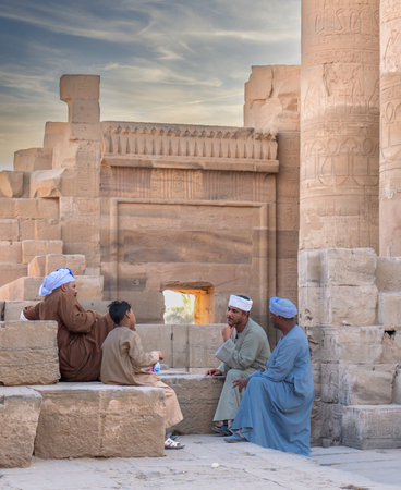 Unidentified people sit at the entrance to the Temple of Hatshepsut in Luxor, Egyptの写真素材