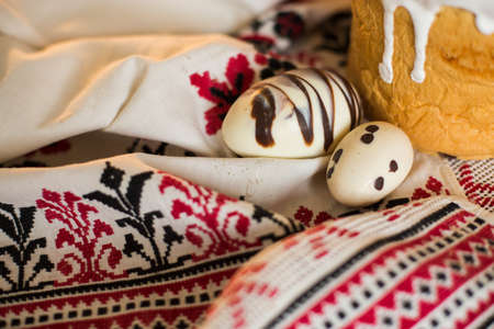 Easter pie in eco-style decorated in the form of a nest with eggs on the background of the national...