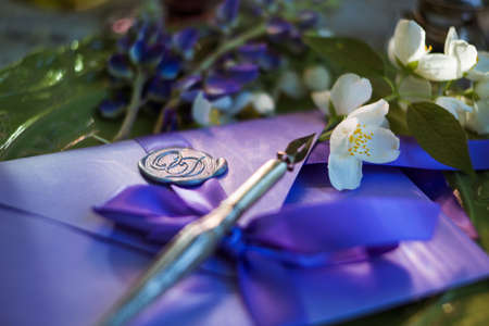 Love romantic letter. Feather pen and inkwell on wood table background