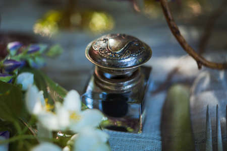Love romantic letter. Feather pen and inkwell on wood table backgroundの写真素材