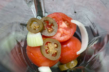 Mexican salsa ingredients inside a blenderの写真素材