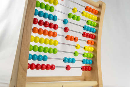 Colorful abacus with the money sign over a white backgroundの写真素材