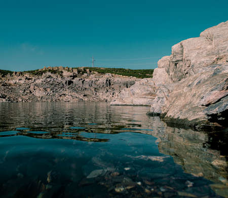 calm water in a lake with rocksの写真素材