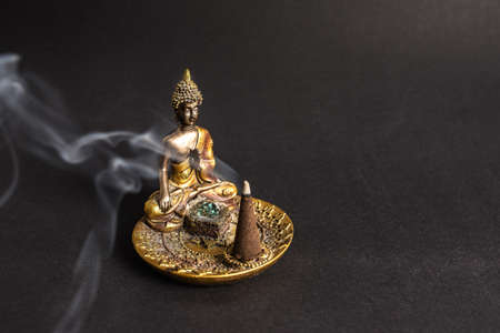 Buddha incence holder with burning cone. Meditation and yoga atmosphereの写真素材