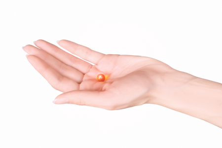 female hand holding a glowing capsule with clipping pathの写真素材