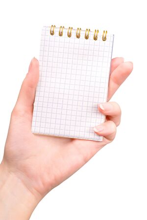 Female hand holding notebook with golden binder isolated on white with clipping path. First person viewの写真素材