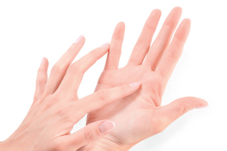 Female hand touching hand isolated on whiteの写真素材