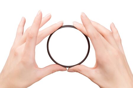 Beautiful woman hands holding the camera filter isolated on white with clipping pathの写真素材