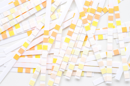 Abstract white background with colored ph paperの写真素材