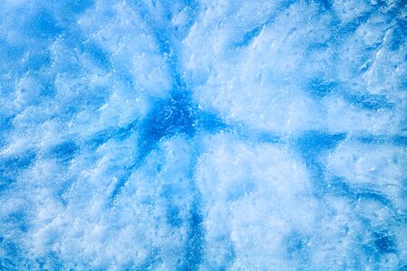 Blue icy surface with dark veins. Texture or backgroundの写真素材