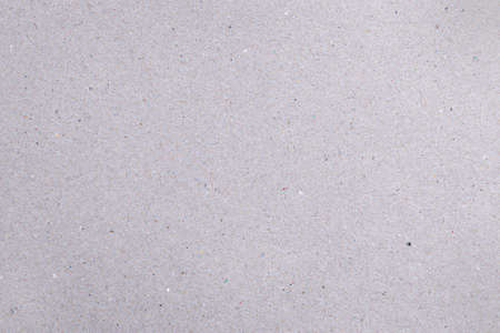 Rough gray natural cardboard background with colored dots and fibersの写真素材