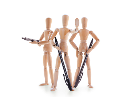Three armed with pens wooden mannequins isolated on white background. Stop sign, legal protection or bureaucratic barriers conceptの写真素材