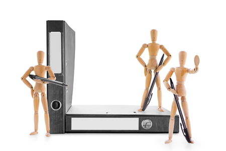Three armed with pens wooden mannequins guarding office folders. Information security, legal protection or bureaucratic barriers conceptの写真素材