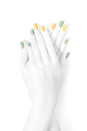 Black and white high-key hands with pastel colored manicure. Isolated with clipping pathの写真素材