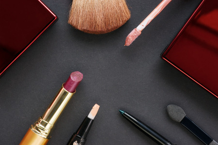 Cosmetics accessories on black cardboard background. Top viewの写真素材