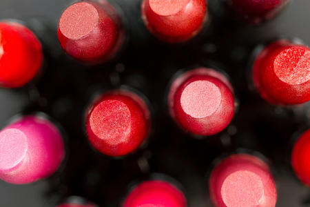 Red lipsticks set close up. On blurred gray background, selective focus on foreground. Top viewの写真素材